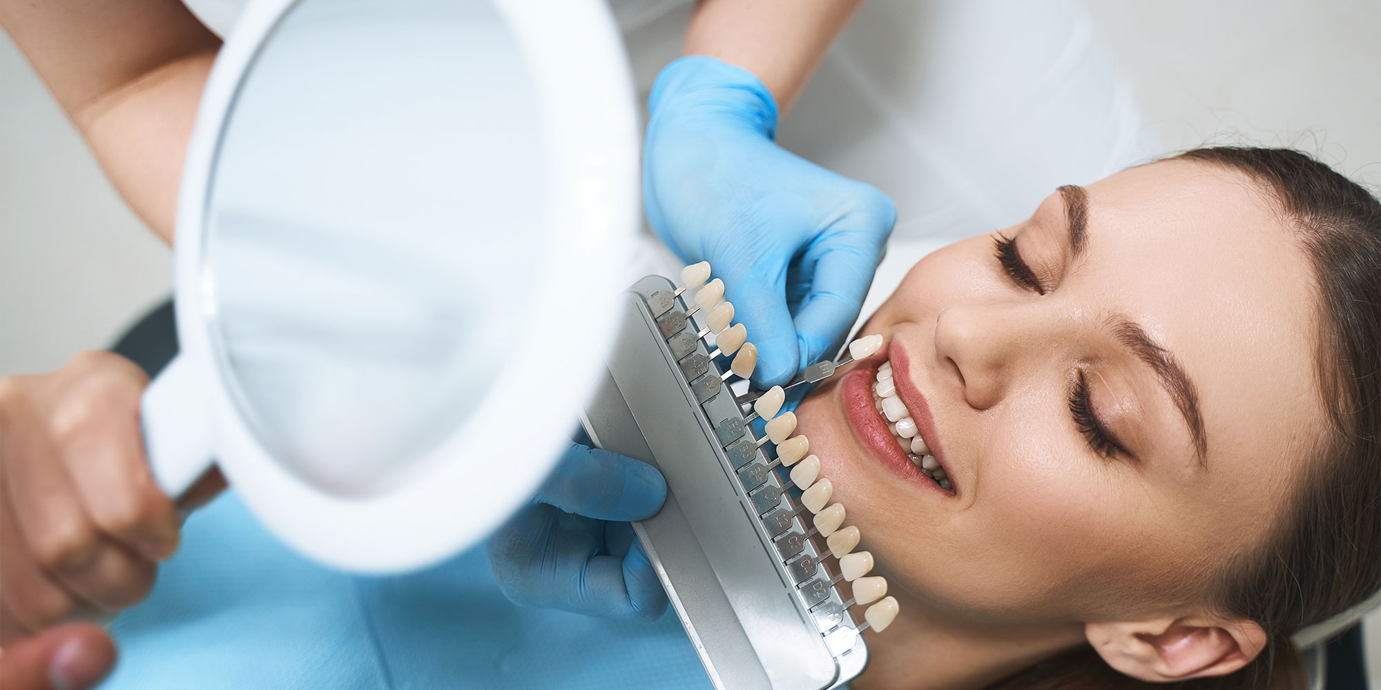 patient comparing veneer models within the dental center