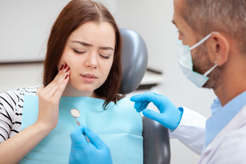 patient with mouth pain within the dental treatment