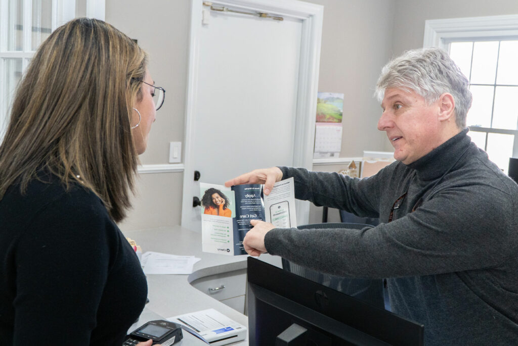 staff member helping patient with going over some financing options for their procedure